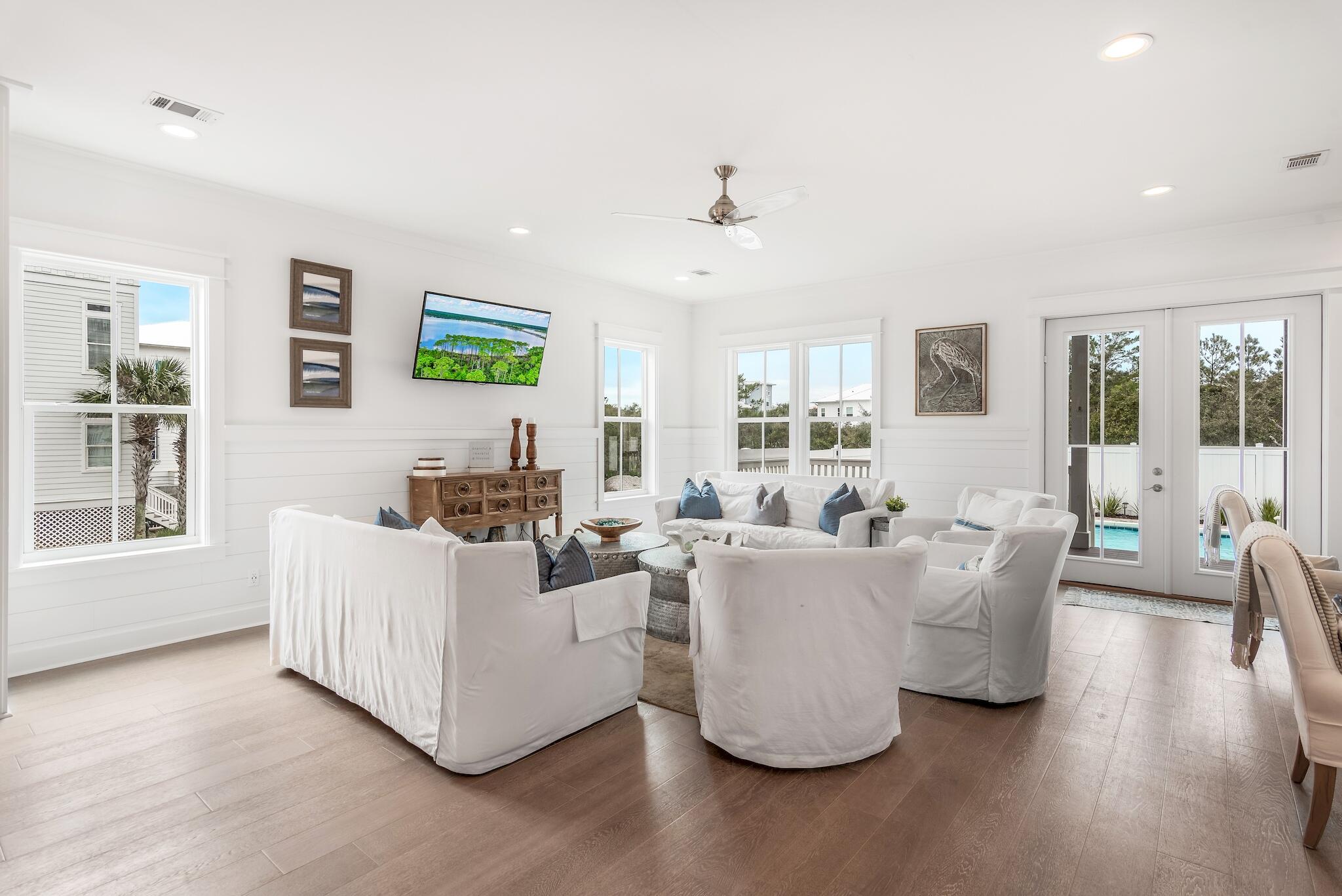 101 A St Inlet Beach Inlet Beach, FL 32461 - Photo 8 of 49 a living room with couches and a flat screen tv with kitchen view