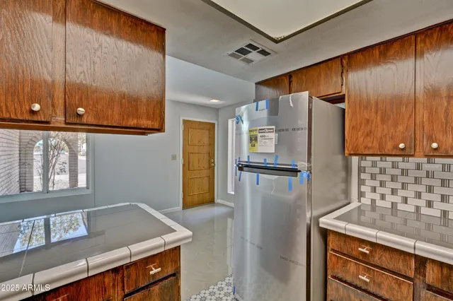 a kitchen with stainless steel appliances granite countertop a refrigerator and a sink