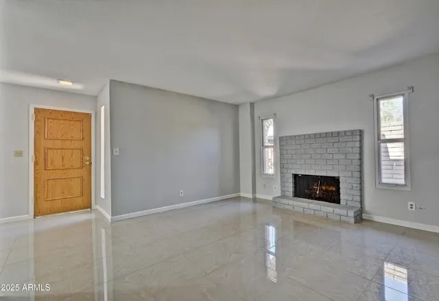 a view of empty room with fireplace