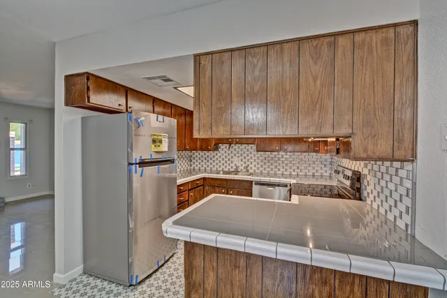 a kitchen with a refrigerator and a sink
