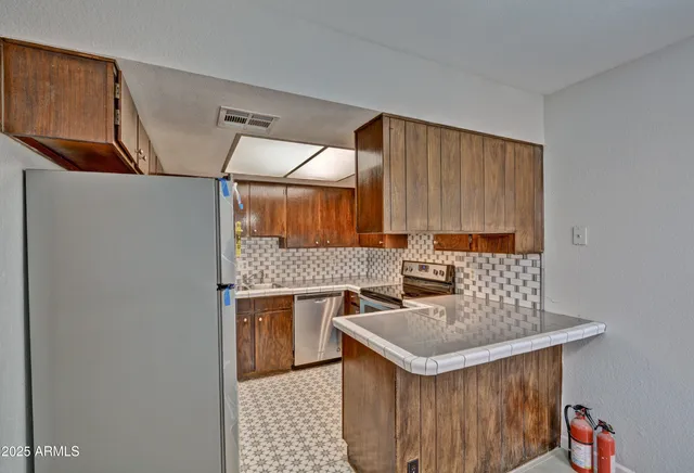 a kitchen with a sink a stove and a refrigerator