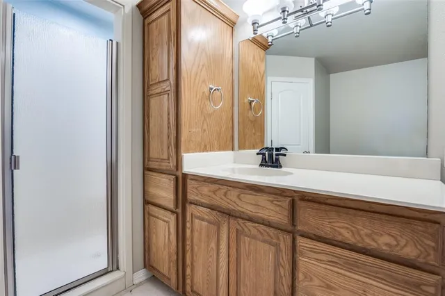 a bathroom with a double vanity sink and a mirror