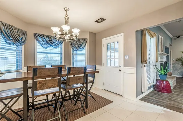 a view of a dining room with furniture and a chandelier
