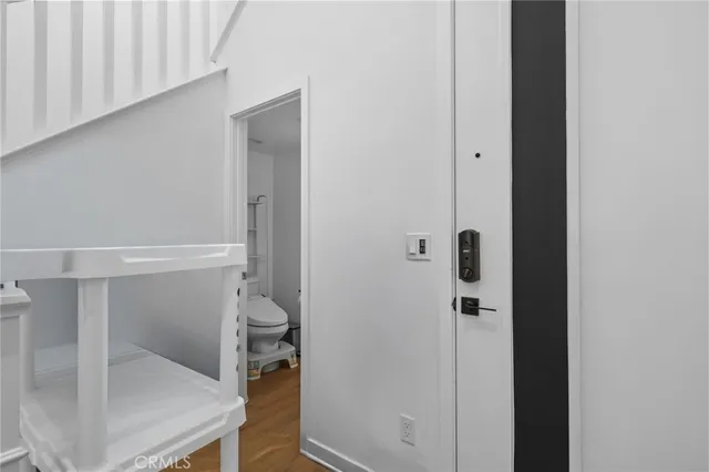 a front view of a house with a yard and potted plants