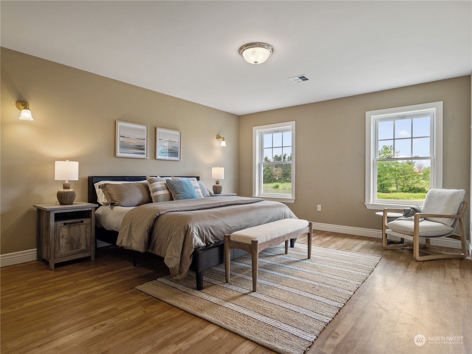 2619 Kitchen-Dick Road Sequim, WA 98382 - Photo 18 of 40 a spacious bedroom with a bed and wooden floor