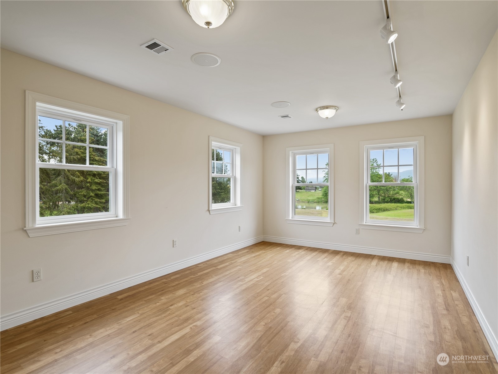 2619 Kitchen-Dick Road Sequim, WA 98382 - Photo 24 of 40 a view of an empty room with wooden floor and a window