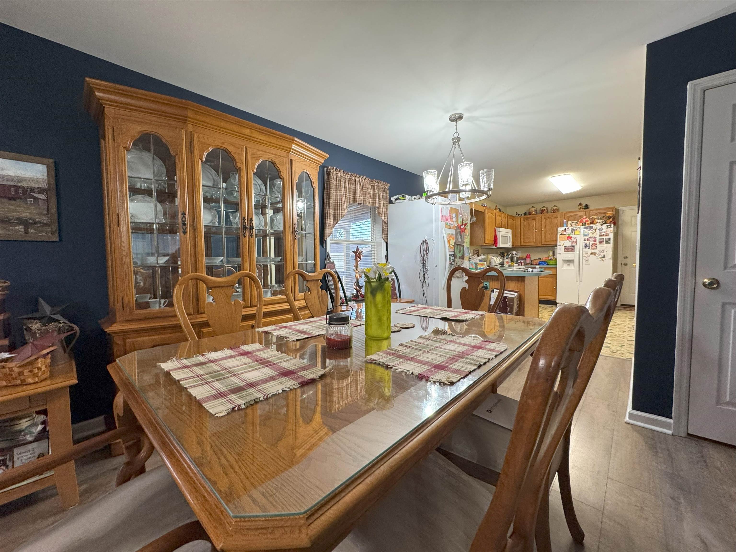 3355 Lyndhurst Road Stuarts Draft, VA 24477 - Photo 22 of 38 a dining room with furniture a chandelier and wooden floor