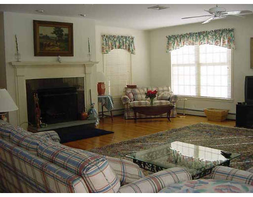 28 Hazen Road Shirley, MA 01464 - Photo 5 of 8 a living room with furniture large window and a fireplace