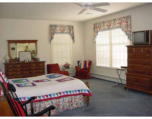 28 Hazen Road Shirley, MA 01464 - Photo 6 of 8 a bedroom with a bed a dresser next to a window