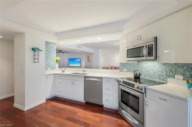 a kitchen with a sink stove and microwave