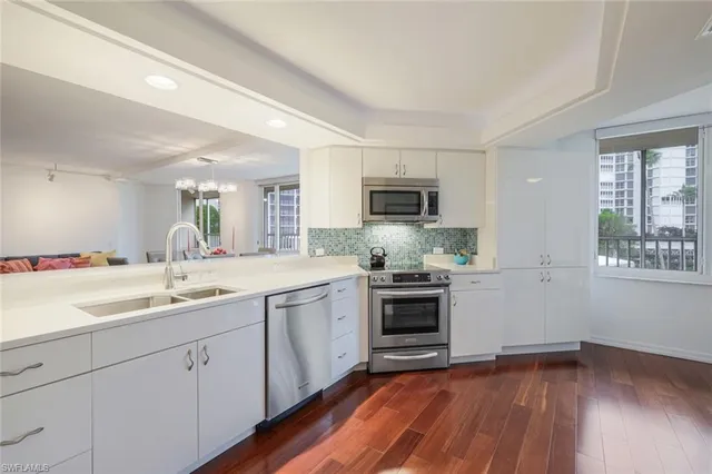 a kitchen with a sink cabinets and stainless steel appliances
