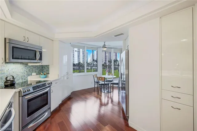 a kitchen with stainless steel appliances granite countertop a stove top oven a sink and cabinets