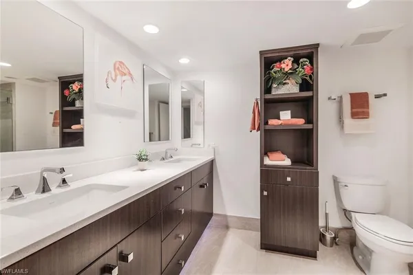 a spacious bathroom with a double vanity sink and a mirror
