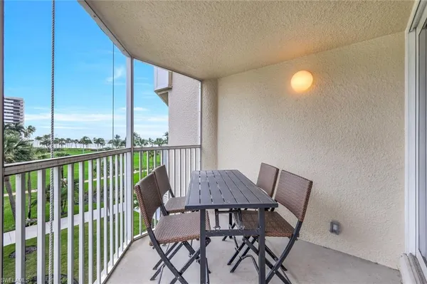 a view of a chairs and table in the balcony