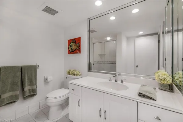 a bathroom with a sink a toilet and mirror