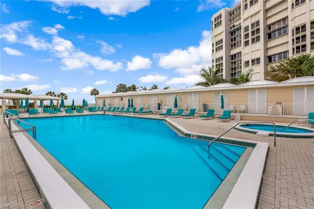 a view of swimming pool with outdoor seating and city view