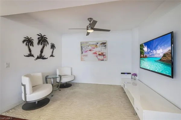 a living room with furniture and wall paintings