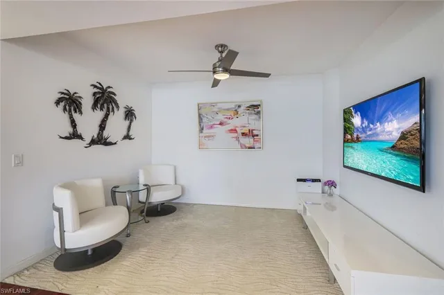 a living room with furniture and wall paintings