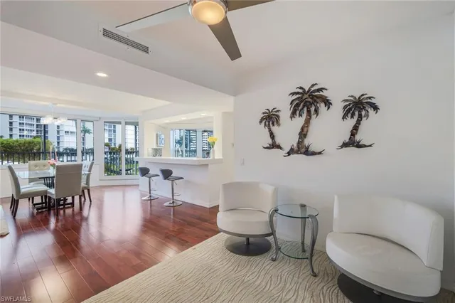 a living room with furniture a wooden floor and a toilet