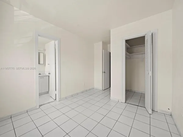 a view of an empty room and closet area