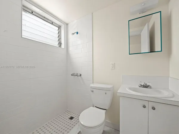 a white toilet sitting next to a bathroom sink
