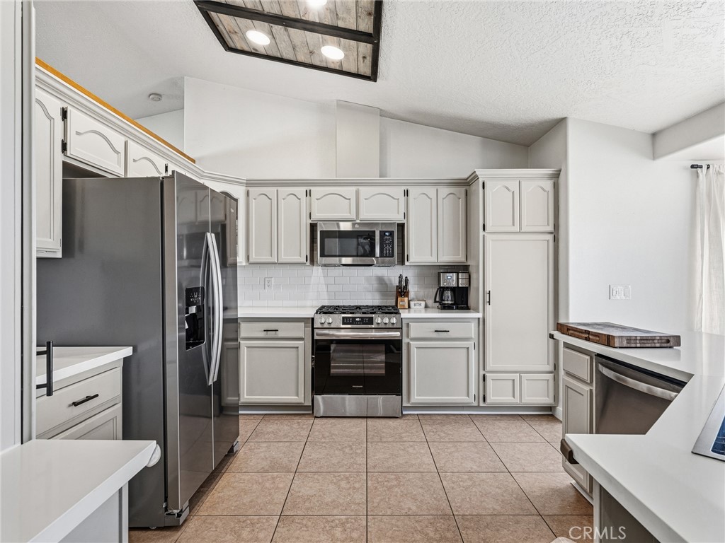 18965 Shetland Road Apple Valley, CA 92308 - Photo 13 of 45 a kitchen with stainless steel appliances a refrigerator sink and stove