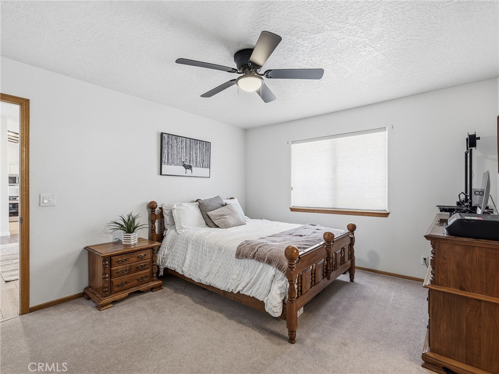 18965 Shetland Road Apple Valley, CA 92308 - Photo 17 of 45 a bedroom with a bed and a window