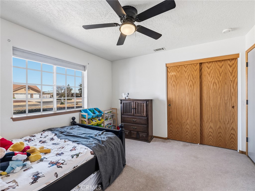 18965 Shetland Road Apple Valley, CA 92308 - Photo 22 of 45 a bedroom with a bed and a window