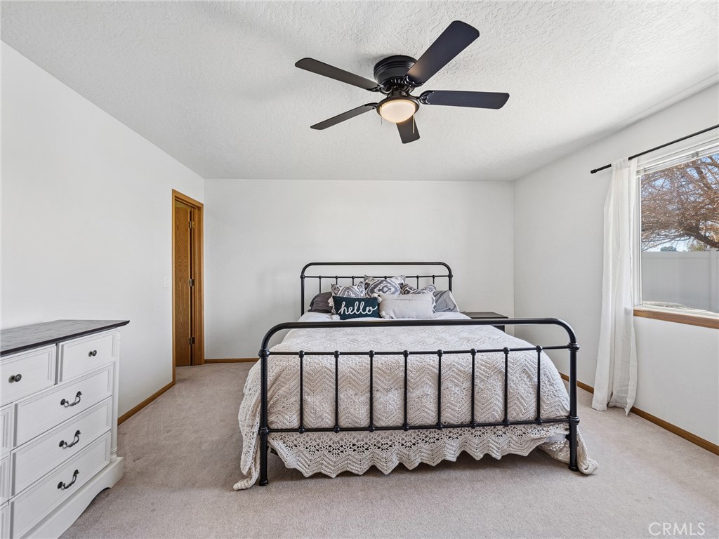18965 Shetland Road Apple Valley, CA 92308 - Photo 25 of 45 a bedroom with a bed dresser and a window