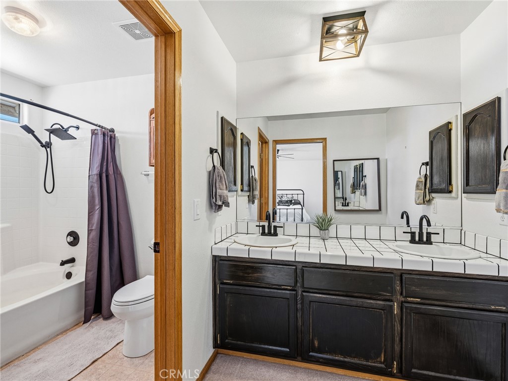 18965 Shetland Road Apple Valley, CA 92308 - Photo 28 of 45 a bathroom with a double vanity sink double mirror and a bathtub