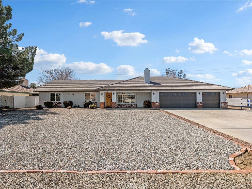 18965 Shetland Road Apple Valley, CA 92308 - Photo 30 of 45 a front view of a house with a yard and balcony