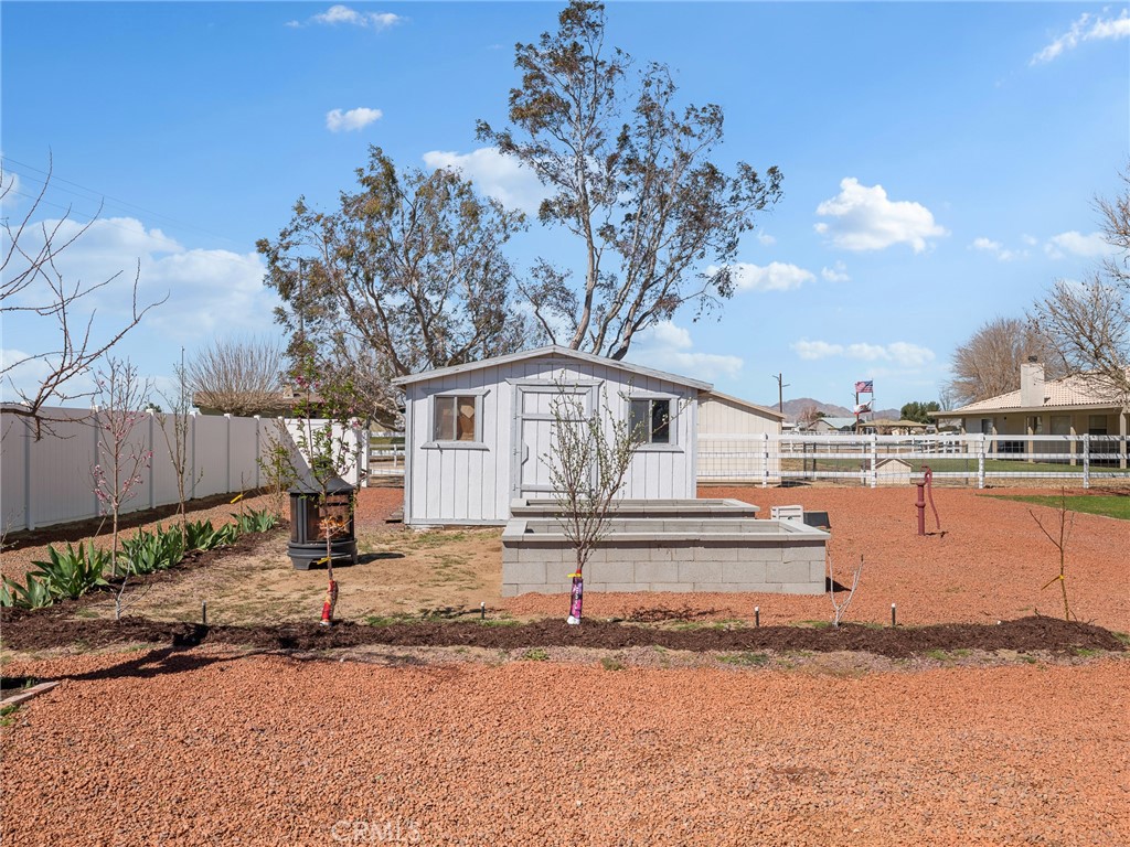 18965 Shetland Road Apple Valley, CA 92308 - Photo 37 of 45 a white house that has a tree in it