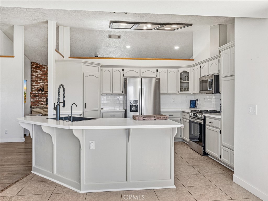 18965 Shetland Road Apple Valley, CA 92308 - Photo 9 of 45 a kitchen with stainless steel appliances granite countertop a sink and stove