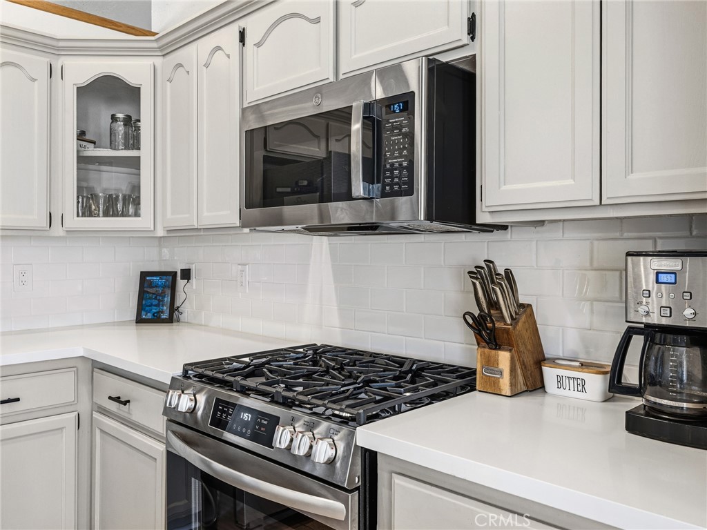18965 Shetland Road Apple Valley, CA 92308 - Photo 10 of 45 a kitchen with granite countertop a stove and a sink