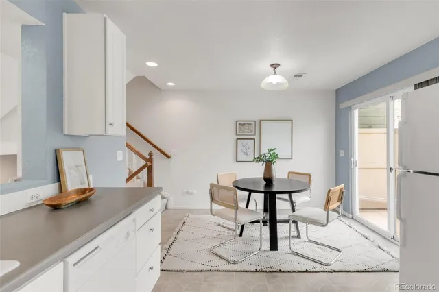a kitchen with white cabinets and white appliances