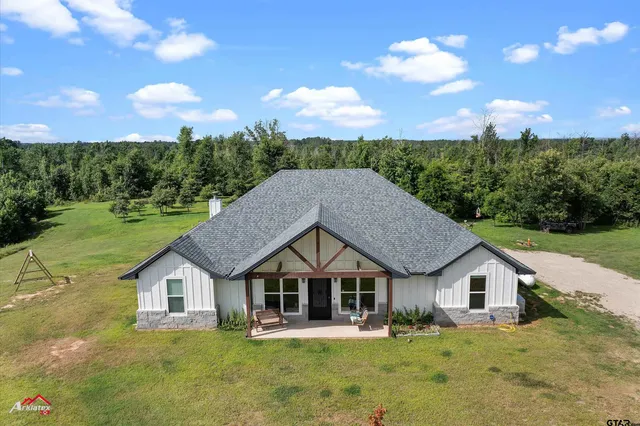 a big house with a big yard and large trees