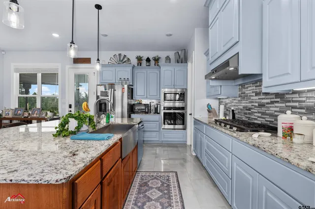a kitchen with a stove and cabinets