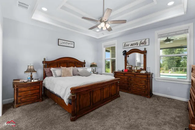 a bedroom with a bed a chandelier and closet