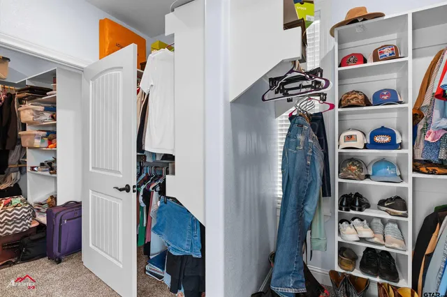 a bathroom with a granite countertop sink a toilet and a shower