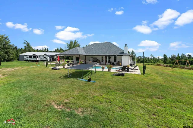 a view of a house with backyard and porch