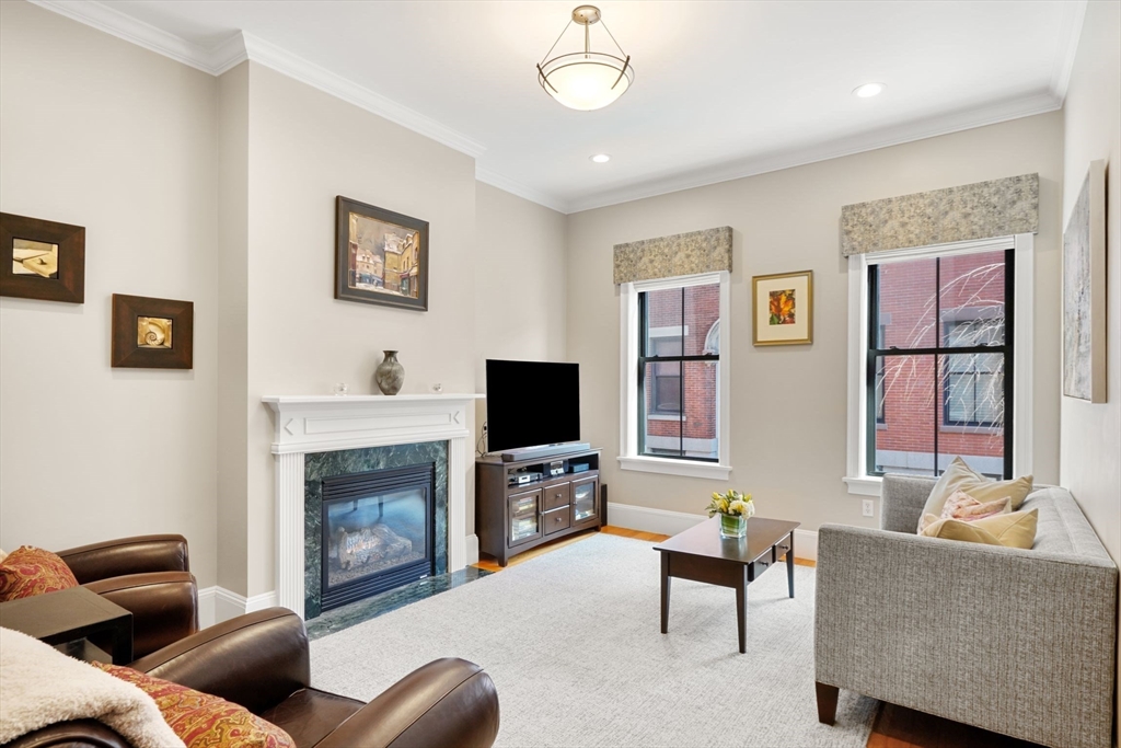 3 Harvard Place, Unit 1 Boston, MA 02129 - Photo 1 of 15 a living room with furniture and a fireplace