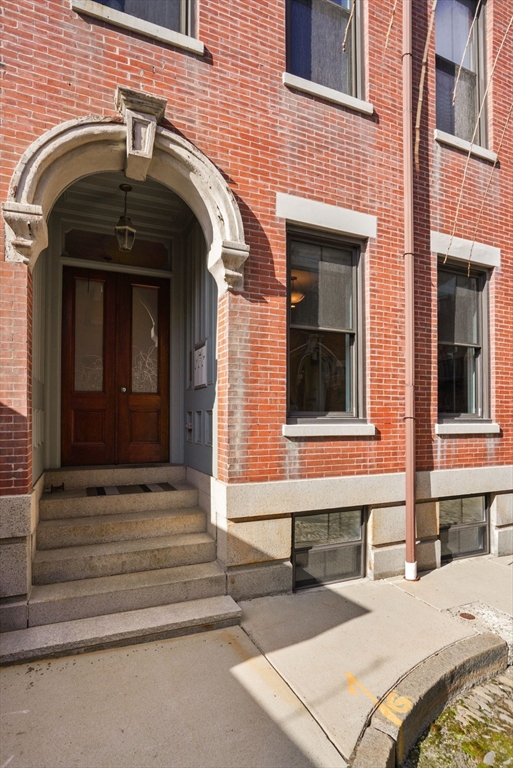 3 Harvard Place, Unit 1 Boston, MA 02129 - Photo 11 of 15 a front view of a house with a door and a window