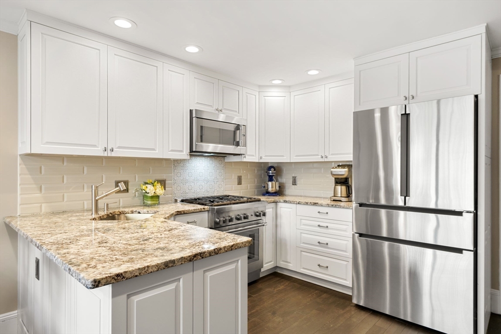 3 Harvard Place, Unit 1 Boston, MA 02129 - Photo 2 of 15 a kitchen with stainless steel appliances granite countertop a refrigerator sink and cabinets