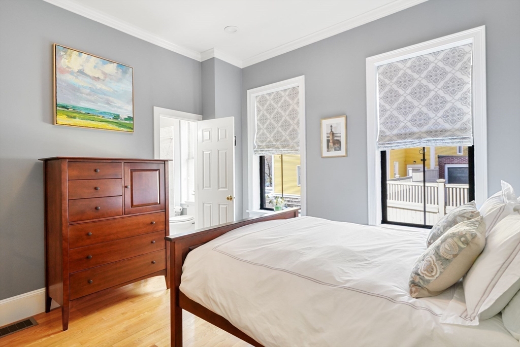 3 Harvard Place, Unit 1 Boston, MA 02129 - Photo 5 of 15 a bedroom with a bed and wooden floor