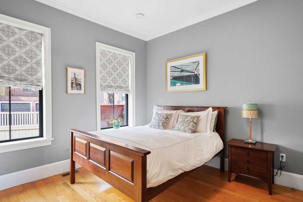 3 Harvard Place, Unit 1 Boston, MA 02129 - Photo 6 of 15 a bedroom with a bed and a lamp on table