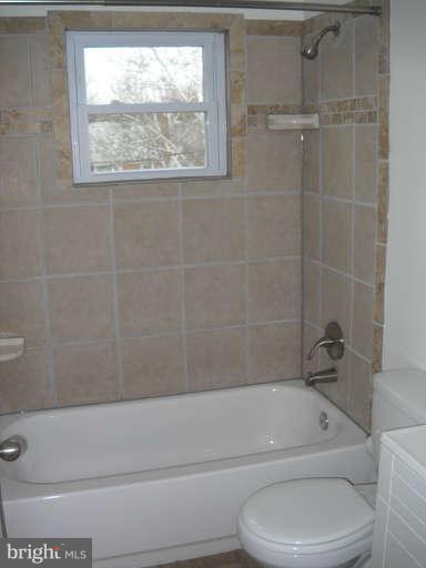 4412 Fenor Road Halethorpe, MD 21227 - Photo 5 of 8 a bathroom with a toilet bathtub and window