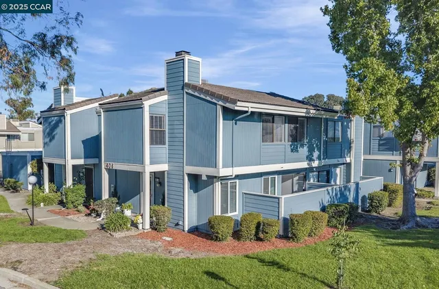 a view of a house with a yard and sitting area