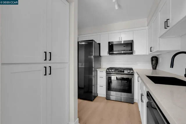 a kitchen with stainless steel appliances a refrigerator stove and microwave