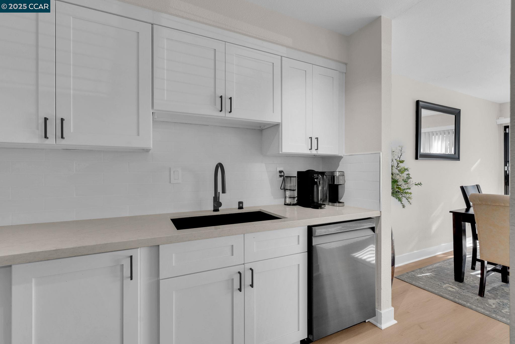 406 Olympus, Unit 5 Hercules, CA 94547 - Photo 13 of 49 a kitchen with white cabinets and a stove with wooden floor