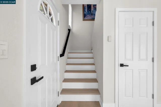 a view of staircase with white walls